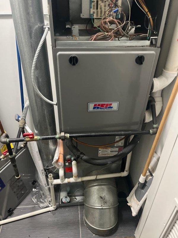 Provided comprehensive estimate for complete HVAC system replacement including furnace and air conditioning unit following previous diagnosis of cracked heat exchanger and ongoing safety concerns. Evaluated existing Heil air handler installation, rooftop condenser units, refrigerant lines, and associated plumbing connections. Presented replacement options to address critical heat exchanger failure, green diagnostic light indication on furnace, and potential water heater leak to ensure system safety and proper operation.
