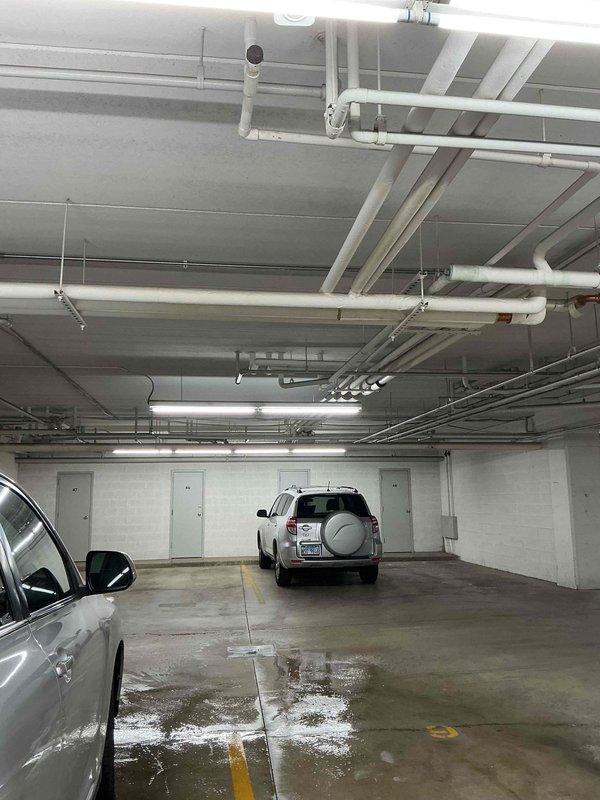 Responded to service call for blocked main condensate drain line in commercial HVAC system. Located condensate drain obstruction causing backup in system serving underground parking garage facility. Cleared blockage from main drain line using appropriate tools and methods, restoring proper drainage flow. Verified thermostat operation showing 77°F and confirmed system functionality upon completion. Tested condensate drainage to ensure complete clearance and proper flow through drain system.
