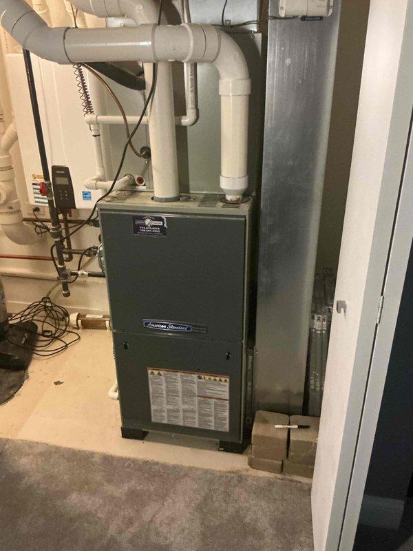 Responded to no cooling call on residential air conditioning system. Upon arrival, inspected American Standard furnace with air handler in basement and outdoor condensing unit. Verified thermostat settings, checked electrical breakers, and confirmed system power supply. Diagnosed non-operational outdoor unit, identifying failed capacitor and contactor issues preventing compressor from starting. Replaced defective dual run capacitor and contactor, restored proper electrical connections at outdoor disconnect. Tested system operation, confirmed proper amperage draw on compressor and fan motor, and verified adequate airflow at supply registers. System restored to full cooling operation with all components functioning within manufacturer specifications.