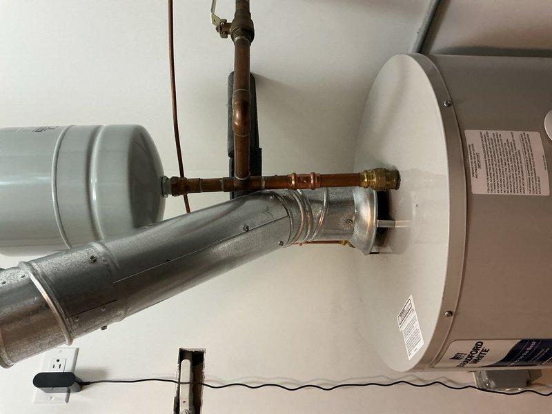 Removed and disposed of existing 50-gallon water heater from basement location. Installed new 50-gallon energy-efficient water heater in same position. Connected unit to existing gas line, electrical supply, water piping, and exhaust chimney venting system. Installed temperature and pressure relief valve assembly with copper supply lines and brass fittings. Verified all connections for proper operation and completed safety inspection of entire system. Unit tested and confirmed operational with 6-year warranty on parts and tank, plus 1-year labor warranty.