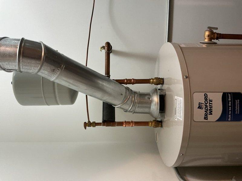 Removed and disposed of existing 50-gallon water heater from basement location. Installed new 50-gallon energy-efficient water heater in same position. Connected unit to existing gas line, electrical supply, water piping, and exhaust chimney venting system. Installed temperature and pressure relief valve assembly with copper supply lines and brass fittings. Verified all connections for proper operation and completed safety inspection of entire system. Unit tested and confirmed operational with 6-year warranty on parts and tank, plus 1-year labor warranty.