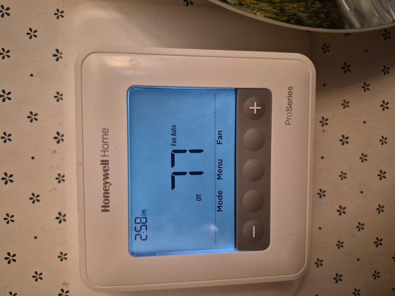Completed Comfort Plan Clean and Check maintenance on single HVAC system. Performed comprehensive inspection of outdoor condensing unit, which showed normal weathering and debris accumulation on condenser coils and top surface. Cleaned condenser coils and removed leaves, dust, and organic matter from unit housing and fins. Verified Honeywell Home ProSeries thermostat operation, confirming proper display function and temperature reading of 71°F. System operating within normal parameters with no deficiencies noted requiring immediate attention.