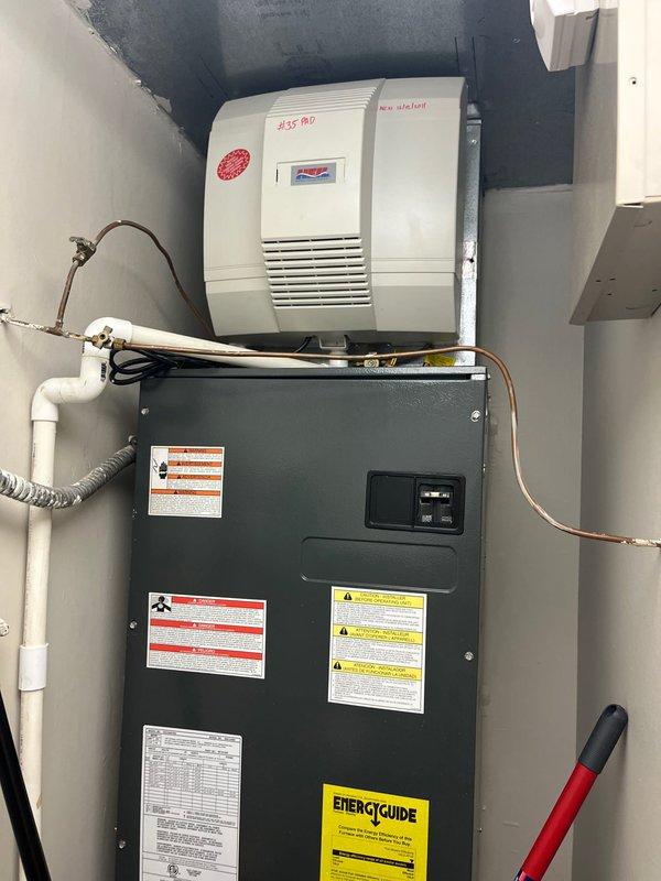 Completed estimate for 2.5 ton air conditioning system replacement at unoccupied property. Assessed existing indoor air handler unit with humidifier and evaluated electrical disconnect panel with dual circuit breakers for compatibility with new equipment installation.