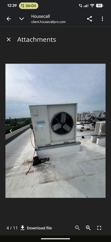 Responded to commercial property for no cooling complaint with rooftop unit not operating. Accessed roof using provided entry code and located affected white packaged HVAC unit among multiple rooftop installations. Performed diagnostic inspection of unit and documented equipment condition with photographs for service records.