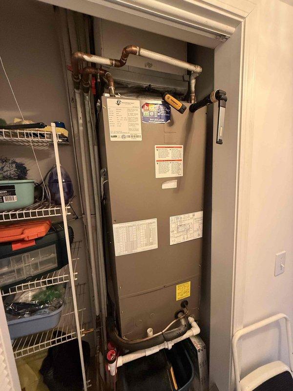 Completed comprehensive Comfort Plan clean and check on single-system HVAC installation, including indoor air handler unit located in utility closet and outdoor condensing unit on rooftop. Performed thorough inspection of both components, verified electrical readings using digital multimeter showing proper voltage at 13.0 volts, examined refrigerant lines and connections, and documented equipment condition with photos. System operating within normal parameters; Comfort Plan renewal processed for continued maintenance coverage.