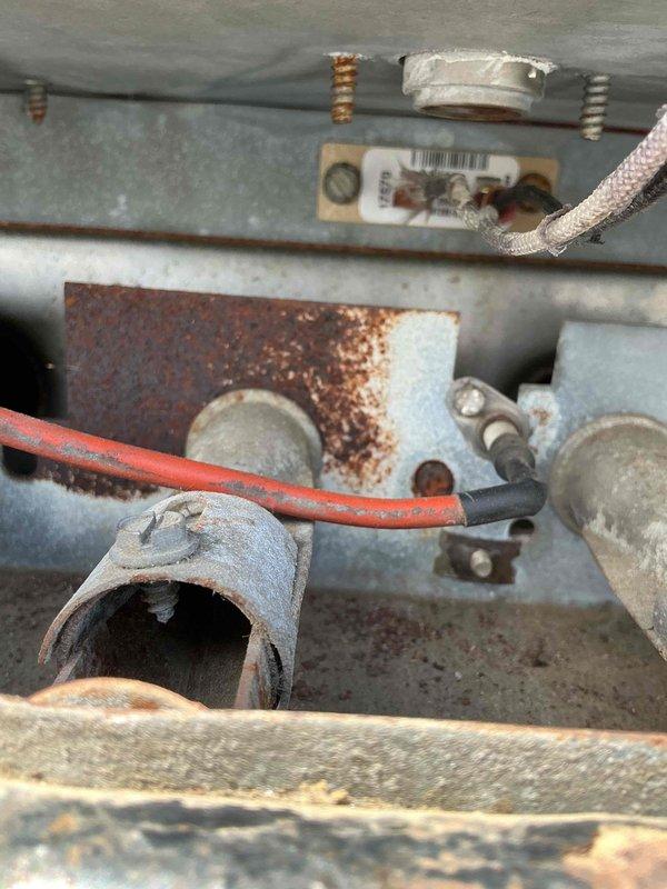 Responded to commercial rooftop unit heating issue on York RTU. Upon inspection, found failed high limit switch requiring replacement. Temporarily disabled heating system by disconnecting W wire at thermostat terminal on main circuit board to prevent unit operation until proper repair could be completed. Documented extensive corrosion on heat exchanger components and internal metalwork, indicating prolonged moisture exposure. Ordered replacement high limit switch for return visit to complete repair and restore heating functionality by reconnecting W wire at circuit board.