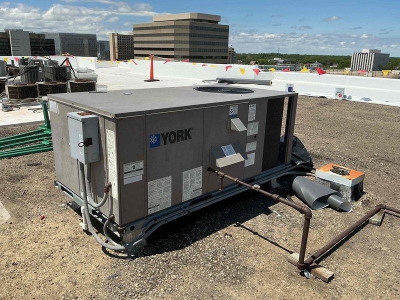 Responded to commercial rooftop unit heating issue on York RTU. Upon inspection, found failed high limit switch requiring replacement. Temporarily disabled heating system by disconnecting W wire at thermostat terminal on main circuit board to prevent unit operation until proper repair could be completed. Documented extensive corrosion on heat exchanger components and internal metalwork, indicating prolonged moisture exposure. Ordered replacement high limit switch for return visit to complete repair and restore heating functionality by reconnecting W wire at circuit board.