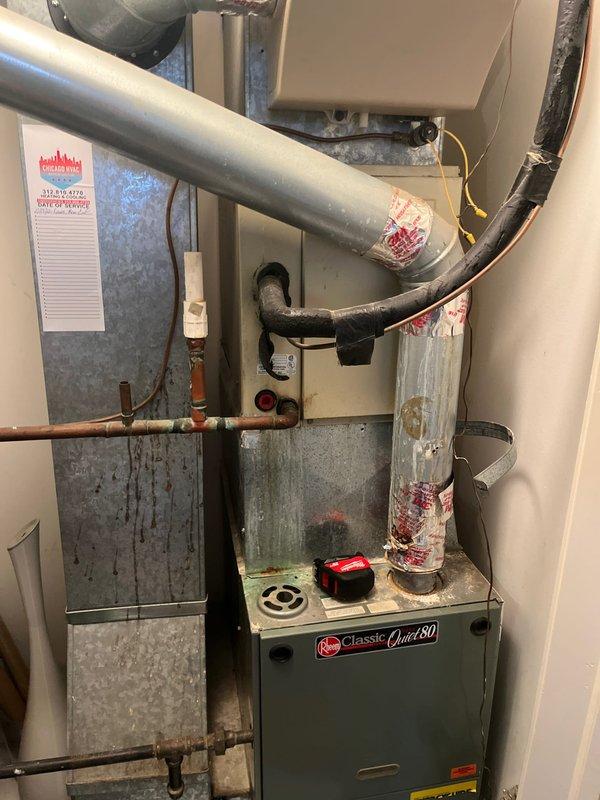 Completed HVAC system replacement estimate for residential property requiring 1.5 ton air conditioning unit installation on roof with crane access and furnace replacement in interior closet. Assessed existing Rheem Classic Quiet 80 furnace installation with associated ductwork, copper refrigerant lines, and electrical connections. Documented current system configuration including galvanized sheet metal supply plenum, insulated flexible ductwork, and mechanical room layout to provide accurate replacement specifications. Evaluated roof access requirements for condenser placement and determined crane lift necessity due to site constraints. Provided comprehensive estimate for complete system replacement including new air handler, condensing unit, refrigerant line set, electrical upgrades, and ductwork modifications as needed for proper installation and code compliance.