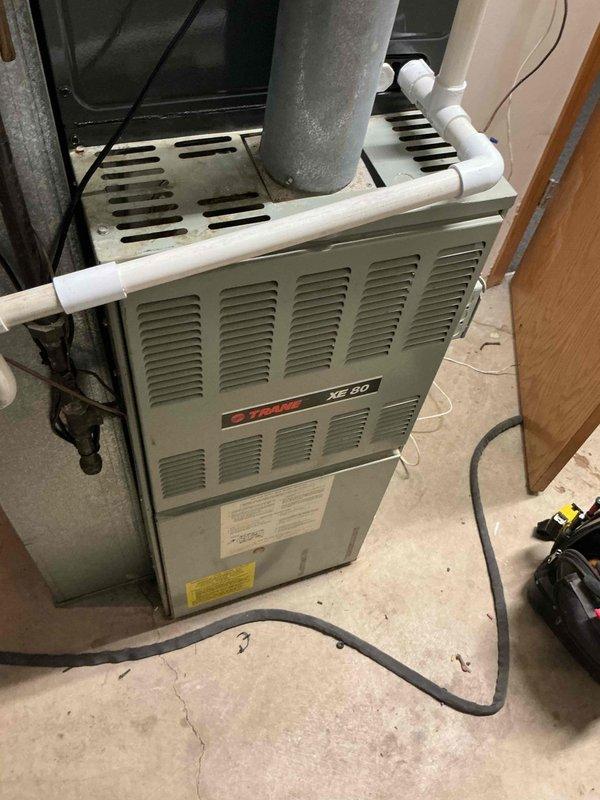 Completed blower motor replacement on Trane XE 80 furnace that was previously attempted but not finished. Installed new blower assembly, verified proper operation of unit, and tested newly installed air conditioning system to ensure full functionality. Confirmed system is running correctly with proper airflow and temperature output reading 44.2°F at supply duct, indicating adequate cooling performance.