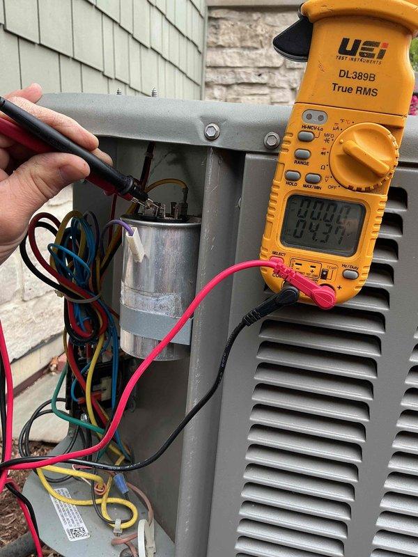 Completed comprehensive clean and check maintenance service on two HVAC systems per comfort plan agreement. Both air conditioning units, originally installed in 2011 (15 years old), received full inspection and preventive maintenance. Humidifier unit, approximately 2 years old, was also serviced. 

Performed electrical diagnostics on outdoor condensing units using digital multimeter to verify proper voltage, amperage, and capacitor performance. Tested all electrical connections and components to ensure safe operation. Inspected capacitors, contactors, and wiring harnesses for signs of wear or degradation.

Accessed indoor air handler and inspected blower wheel assembly. Found significant dust and debris accumulation on lower portion of squirrel cage blower, with buildup creating noticeable gradient from clean upper blades to heavily contaminated lower section. This accumulation pattern indicated extended operation without maintenance and potential for reduced airflow efficiency.

Clean