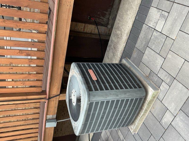Reconnected outdoor condenser unit #6 to system following previous service work. Performed system flush and vacuum procedures to remove contaminants and moisture from refrigerant lines. Unit positioned on concrete pad against exterior wall with proper clearances maintained. Ticket paused pending refrigerant charging on separate work order to ensure accurate weight measurement and billing documentation.