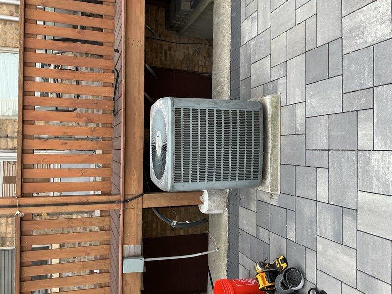 Reconnected outdoor condenser unit #6 to system following previous service work. Performed system flush and vacuum procedures to remove contaminants and moisture from refrigerant lines. Unit positioned on concrete pad against exterior wall with proper clearances maintained. Ticket paused pending refrigerant charging on separate work order to ensure accurate weight measurement and billing documentation.
