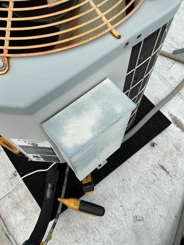 Completed comfort plan clean and check maintenance on 18-year-old Carrier rooftop HVAC system. Performed standard inspection procedures including visual examination of condenser unit, fan assembly, and exterior components. Noted visible corrosion on copper fan guard and typical wear consistent with unit age. Documented system condition with photographs showing rooftop installation layout and equipment status. Based on unit age and manufacturer history, flagged potential heat exchanger concerns for future monitoring, particularly in area behind high limit switch where cracks commonly develop in older Carrier furnaces.