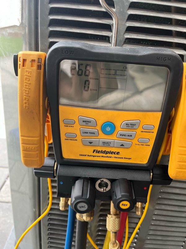 Responded to service call for HVAC system requiring refrigerant charge. Upon arrival, accessed outdoor condensing unit located beneath elevated deck structure. Connected Fieldpiece digital manifold gauge set to service ports and performed system pressure diagnostics on both low and high sides. System readings confirmed low refrigerant charge. Added appropriate amount of refrigerant per manufacturer specifications and monitored pressures to ensure proper levels were achieved. Verified system operation and confirmed unit was cooling properly with correct superheat and subcooling values. System returned to normal operating parameters upon completion of refrigerant charge.