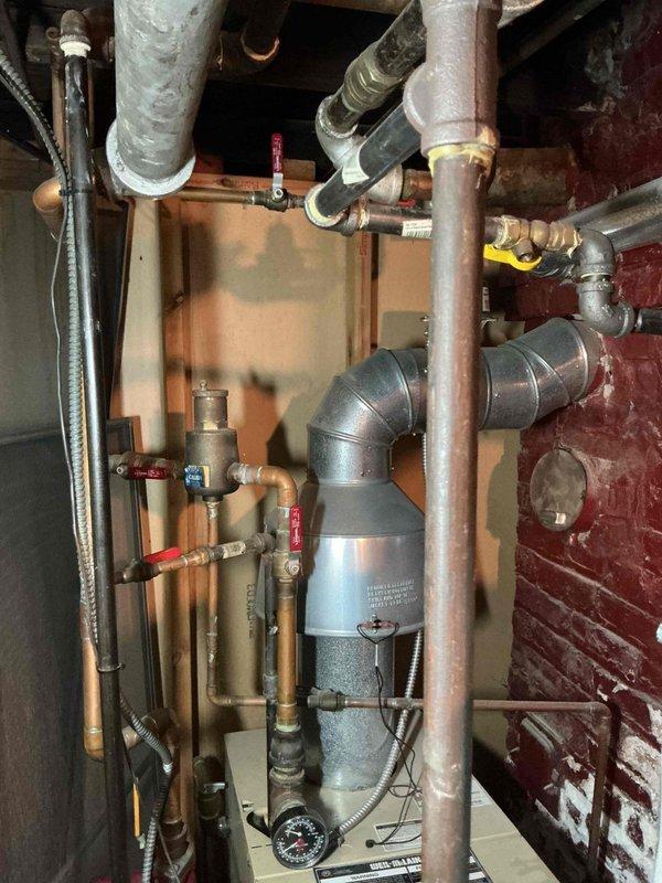 Responded to service call for hydronic heating system with non-operational radiators identified during home inspection. Performed diagnostic evaluation of boiler and circulation system, including inspection of pressure gauge readings, zone valves, and circulator pump operation. Assessed system pressure, verified proper operation of ball valves and control components, examined piping connections and flex lines for integrity, and tested heating zones to restore functionality to radiator distribution system.