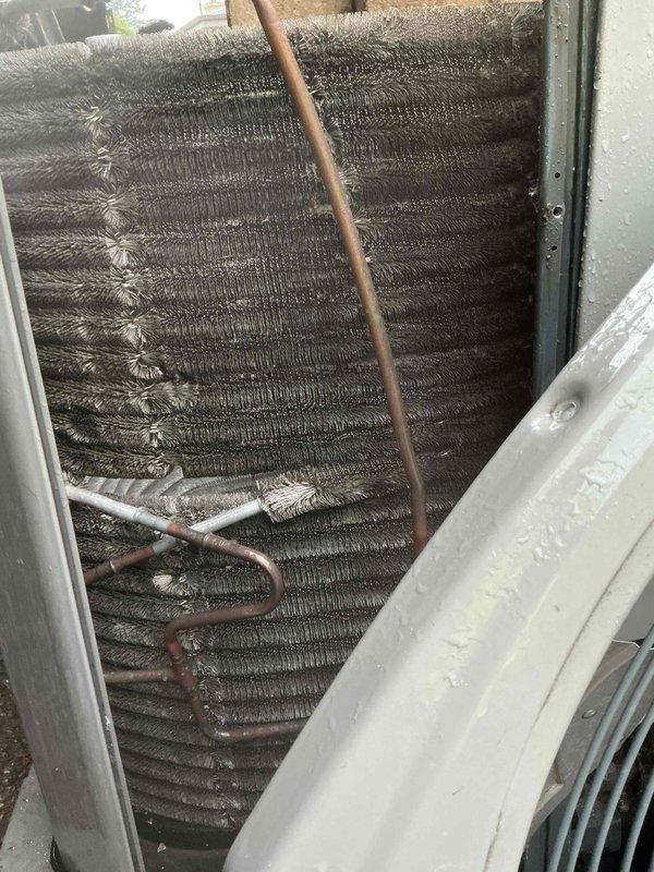 # HVAC Condenser Coil Cleaning

Performed comprehensive cleaning of outdoor air conditioning condenser unit due to heavy accumulation of dirt, dust, and debris on coil fins. The evaporator coils exhibited significant particulate buildup that was restricting airflow and reducing heat transfer efficiency. Thoroughly cleaned all coil surfaces using appropriate methods to remove matted debris from between aluminum fins and restored proper airflow through the unit. Inspected refrigerant lines and connections during service. Upon completion, unit demonstrated improved operational efficiency and restored cooling capacity.