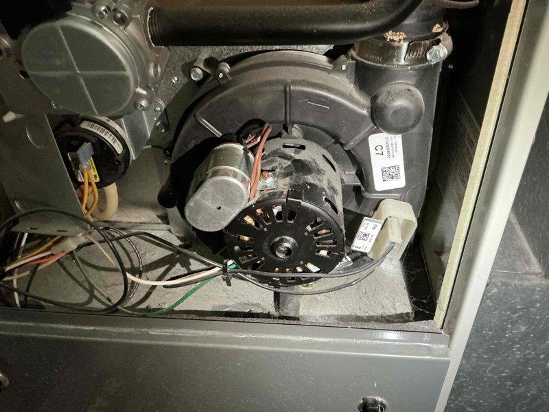 Responded to service call for furnace exhaust motor replacement. Upon arrival, performed diagnostic inspection of the furnace system and confirmed the exhaust motor required replacement. Accessed the blower compartment, documented existing equipment configuration with photos, and verified all electrical connections and wiring to the motor assembly. Inspected the blower housing, pressure switches, and associated ductwork for proper operation. Discussed repair options with customer and entered complete equipment information into service records for future reference.