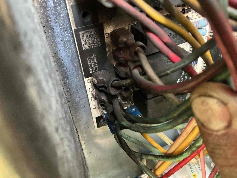 Responded to no cooling call on residential air handler unit approximately 6-9 years old. Upon arrival, performed system diagnostics and inspected blower motor assembly and electrical connections within the air handler cabinet. Verified proper motor operation, checked wire terminations at junction box for secure connections and signs of overheating or failure. Inspected blower wheel for obstructions and proper rotation. Noted unit installed at ground level with some debris accumulation at base. Tested electrical components and motor capacitor functionality. System returned to normal cooling operation following inspection and minor adjustments to electrical connections.