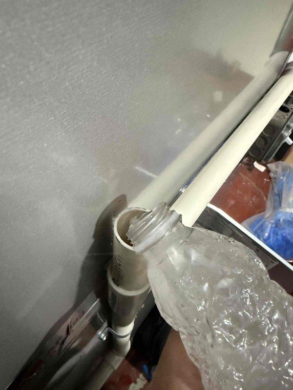 Completed preventative maintenance tune-up on single-zone residential HVAC system located in basement utility area. Performed comprehensive inspection of furnace and air conditioning components, including evaporator coil which showed normal condensation patterns indicating proper operation. Verified condensate drain line functionality with visible water flow through clear tubing and proper drainage through PVC piping system. Inspected all electrical connections, ductwork connections including flexible metallic ducting, and verified proper clearances around equipment. System operating within normal parameters with no deficiencies noted at time of service.