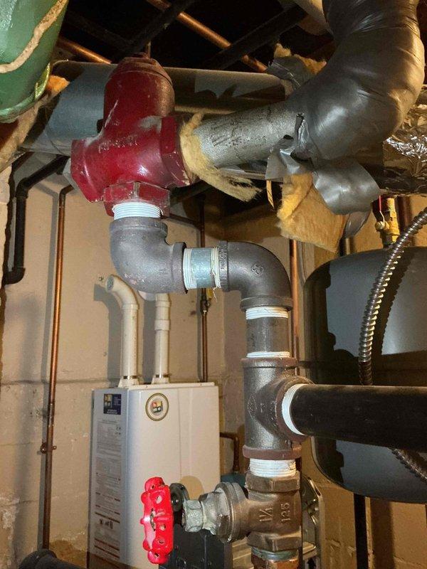Replaced the existing flow control valve with a new air separator in the hydronic heating system and reconnected the existing expansion tank to the new component. Drained the system to facilitate the installation, installed all necessary fittings and connections, and refilled the system to restore proper operation. The new air separator is now functioning to remove entrained air from the circulating water, improving system efficiency and reducing potential noise issues.