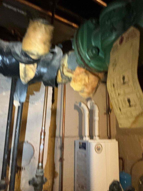 Replaced the existing flow control valve with a new air separator in the hydronic heating system and reconnected the existing expansion tank to the new component. Drained the system to facilitate the installation, installed all necessary fittings and connections, and refilled the system to restore proper operation. The new air separator is now functioning to remove entrained air from the circulating water, improving system efficiency and reducing potential noise issues.