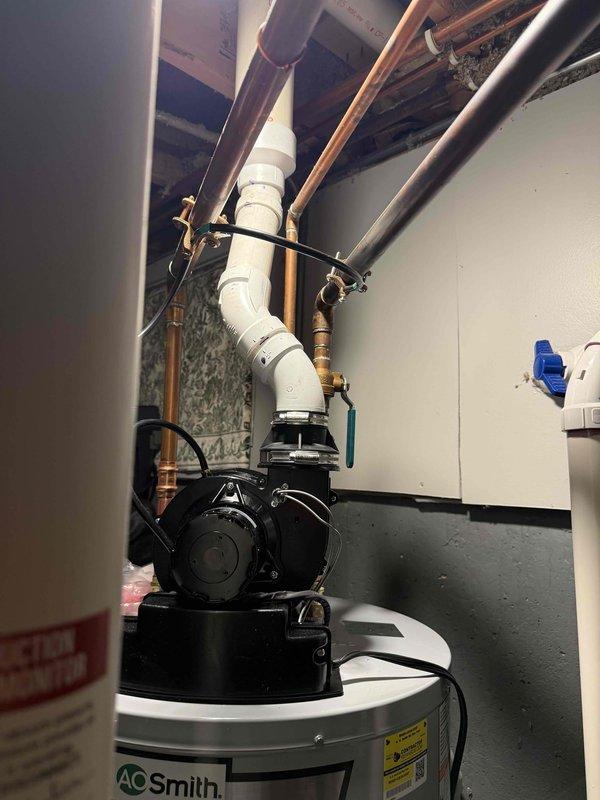 Removed and disposed of existing A.O. Smith water heater from basement location. Drained tank completely using pump to expedite water removal process. Disconnected all utility connections including gas line, electrical supply, water supply piping, and existing power vent exhaust system.

Installed new 50-gallon A.O. Smith power vent water heater in same basement location. Positioned unit on floor and leveled for proper operation. Connected unit to existing PVC power vent exhaust piping system, ensuring proper sealing and venting configuration. Made all necessary water supply and outlet connections to existing copper piping using appropriate fittings and transition connections.

Connected gas supply line to water heater gas valve using existing gas piping infrastructure. Made electrical connections to power vent blower motor and unit controls per manufacturer specifications. Installed circulation pump on top of water heater tank with proper mounting and secured all piping connections. C