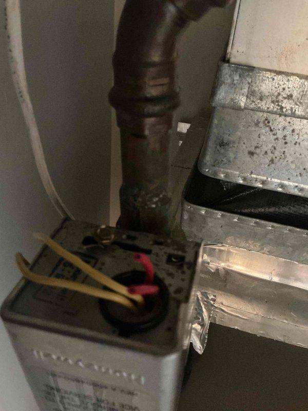 Responded to callback for AC system not cooling below 86 degrees following previous service visit. Performed diagnostic inspection of HVAC equipment in mechanical room, examining condensate drainage system, ductwork integrity, and internal cabinet components. Inspected copper refrigerant lines showing oxidation and corrosion, verified ball valve operation, and assessed heat exchanger condition with visible staining. Conducted electrical system evaluation including wire connections and terminations. Used diagnostic measurement equipment to test system performance parameters and identify root cause of insufficient cooling capacity.