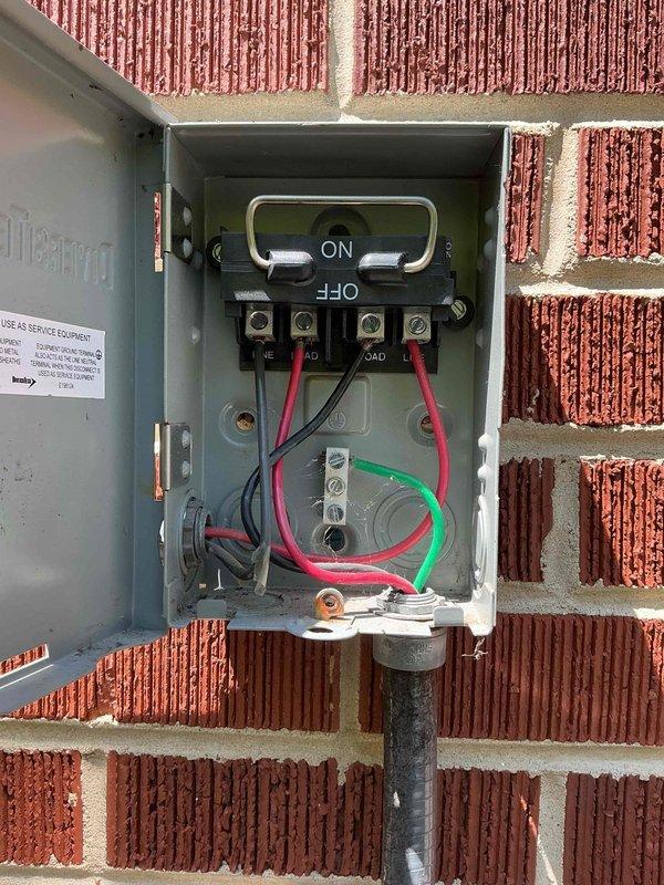 Responded to emergency callback for first floor A/C system with reported water damage to interior ceiling. Upon arrival, found electrical disconnect box improperly mounted to exterior wall with loose wiring connections creating unsafe operating conditions. Remounted disconnect enclosure and re-terminated all line and load connections to restore temporary functionality. Observed condensate drainage system in attic space and verified condensate pump operation. Due to inherent structural deficiencies in disconnect box mounting system, current repair is temporary solution only—wiring will likely become displaced during future service access. Provided estimate for permanent disconnect replacement to ensure safe, code-compliant installation. Coordinated with management regarding water intrusion concerns and previous service history on this unit.