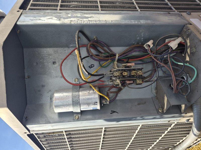 Completed preventative maintenance tune-up on 2.5-ton split system air conditioning unit. Performed electrical diagnostics with multimeter, inspected contactor and capacitor operation, verified all wire connections secure in control compartment. Unit found clean and clear with no filter present; system operating within normal parameters at time of service.