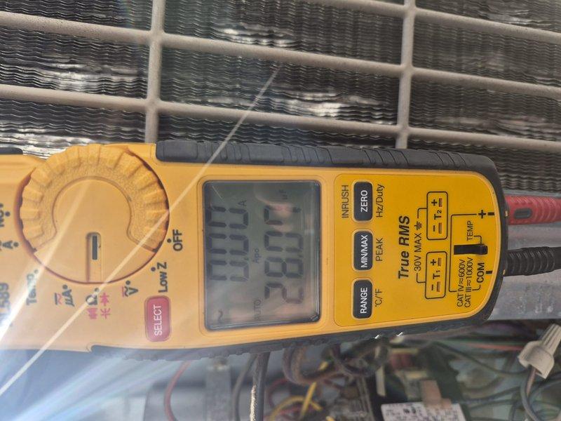 Completed preventative maintenance tune-up on 2.5-ton split system air conditioning unit. Performed electrical diagnostics with multimeter, inspected contactor and capacitor operation, verified all wire connections secure in control compartment. Unit found clean and clear with no filter present; system operating within normal parameters at time of service.