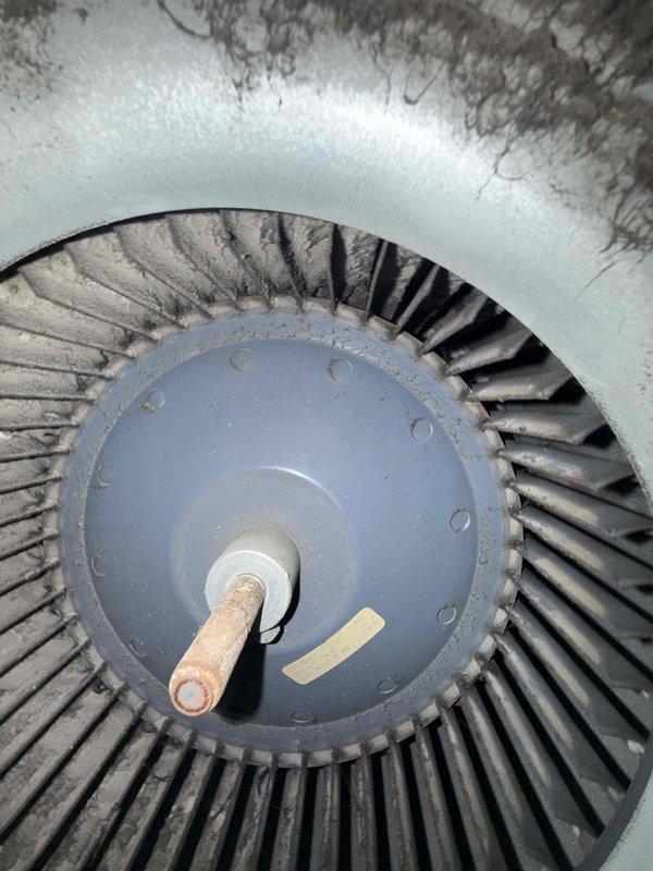 Responded to cooling complaint on residential HVAC system over 10 years old. Upon inspection, discovered significant dust and debris accumulation on blower wheel assembly and interior housing components. Documented condition of squirrel cage blower with extensive particulate buildup affecting airflow efficiency, which was likely contributing to reduced cooling performance.