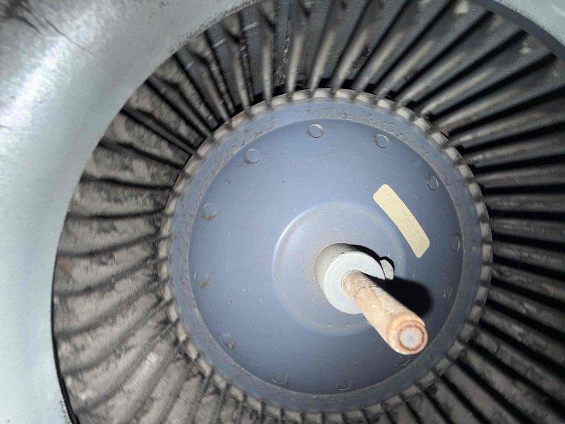 Responded to cooling complaint on residential HVAC system over 10 years old. Upon inspection, discovered significant dust and debris accumulation on blower wheel assembly and interior housing components. Documented condition of squirrel cage blower with extensive particulate buildup affecting airflow efficiency, which was likely contributing to reduced cooling performance.