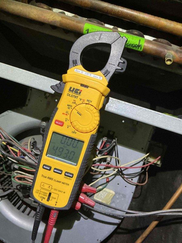 Responded to no cooling complaint at condo unit with rooftop HVAC system. Upon arrival, performed system diagnostics using clamp meter to measure electrical draw, recording 425.0 amp reading at condenser unit. Inspected Lennox outdoor equipment including condenser with top-mounted fan assembly and verified proper electrical connections at control panel. Evaluated copper refrigerant line set condition, noting oxidation consistent with system age. Checked thermostat settings, air filter condition, and electrical breakers as part of standard troubleshooting protocol. Documented equipment information and captured diagnostic readings for service records.