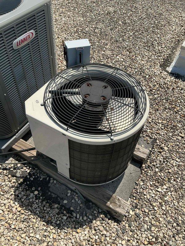 Responded to no cooling complaint at condo unit with rooftop HVAC system. Upon arrival, performed system diagnostics using clamp meter to measure electrical draw, recording 425.0 amp reading at condenser unit. Inspected Lennox outdoor equipment including condenser with top-mounted fan assembly and verified proper electrical connections at control panel. Evaluated copper refrigerant line set condition, noting oxidation consistent with system age. Checked thermostat settings, air filter condition, and electrical breakers as part of standard troubleshooting protocol. Documented equipment information and captured diagnostic readings for service records.