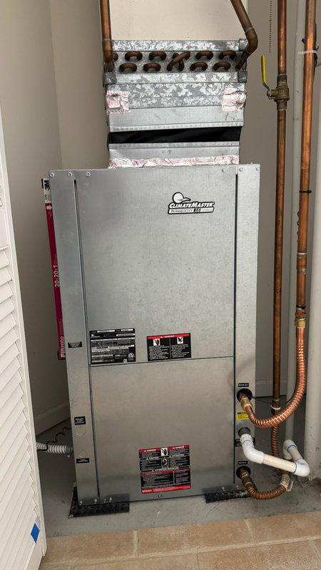 Responded to no cooling complaint on ClimateMaster Tranquility 16 Compact EarthPure geothermal heat pump system. Performed diagnostic evaluation of air handler unit and evaporator coil assembly, verified thermostat settings, inspected air filter condition, and confirmed electrical breaker status. Documented equipment model information and photographed system installation including refrigerant line connections, condensate drainage, and overall unit condition for service records.