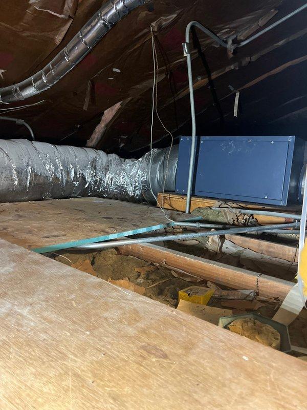 Conducted comprehensive assessment of existing SpacePak high-velocity HVAC system located in attic space, accessed via two-step entry. System evaluation revealed unit is over 25 years old and has reached end of serviceable life. Documented current installation including blue air handler mounted on wooden platform, extensive flexible ductwork with reflective insulation, and Honeywell Home digital thermostat currently operating in cooling mode at 71°F setpoint. Provided detailed replacement estimate for complete SpacePak system upgrade.