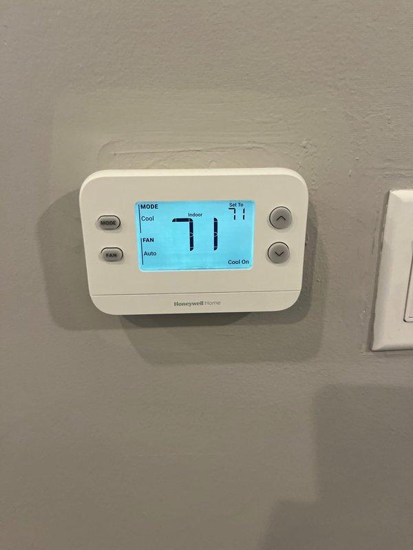 Conducted comprehensive assessment of existing SpacePak high-velocity HVAC system located in attic space, accessed via two-step entry. System evaluation revealed unit is over 25 years old and has reached end of serviceable life. Documented current installation including blue air handler mounted on wooden platform, extensive flexible ductwork with reflective insulation, and Honeywell Home digital thermostat currently operating in cooling mode at 71°F setpoint. Provided detailed replacement estimate for complete SpacePak system upgrade.