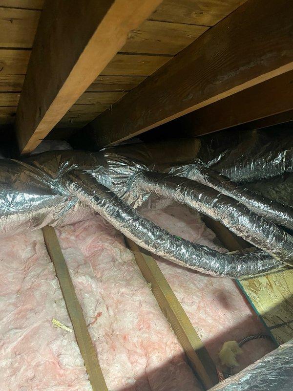 Completed full Unico high-velocity HVAC system installation, including flexible ductwork routing through attic space with proper insulation clearances and installation of supply outlets with decorative wall escutcheons. System tested and verified operational, with customer enrolled in comfort maintenance plan.