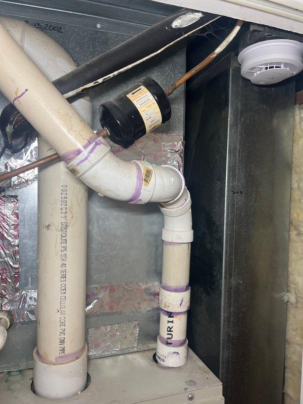 Conducted comprehensive evaluation of existing HVAC system for replacement estimate. Assessed 20-year-old Gibson AC condenser unit located on exterior concrete pad and inspected indoor air handler with condensate drainage system including pump assembly and PVC piping configuration in mechanical space. Documented current equipment condition, photographed existing installations, and provided recommendations for complete system replacement to improve efficiency and reliability.