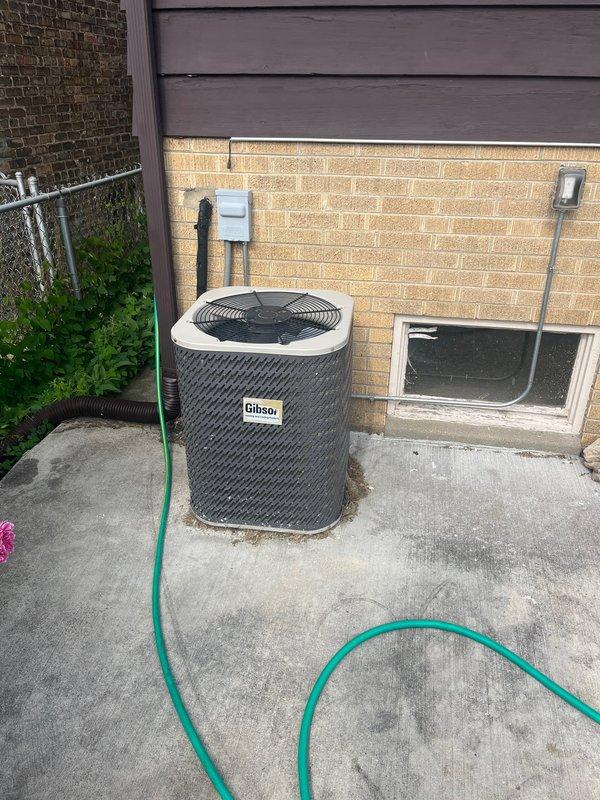 Conducted comprehensive evaluation of existing HVAC system for replacement estimate. Assessed 20-year-old Gibson AC condenser unit located on exterior concrete pad and inspected indoor air handler with condensate drainage system including pump assembly and PVC piping configuration in mechanical space. Documented current equipment condition, photographed existing installations, and provided recommendations for complete system replacement to improve efficiency and reliability.