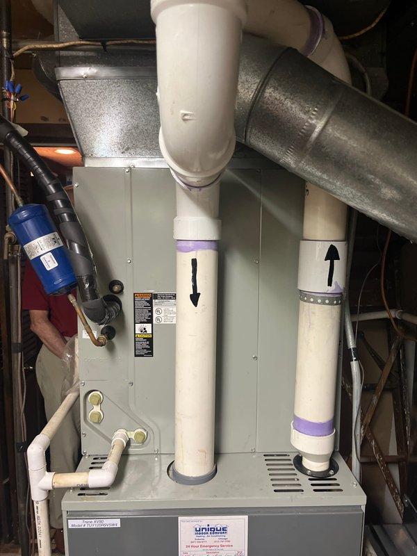Responded to service call for 20-year-old HVAC system blowing warm air. Diagnostic evaluation revealed condenser unit approximately 4-5 lbs low on R22 refrigerant and cracked heat exchanger in furnace. Due to age of equipment, obsolete R22 refrigerant, and critical safety issue with compromised heat exchanger, provided comprehensive estimate for complete system replacement. Documented existing indoor air handler/furnace installation and outdoor condenser unit with photographic evidence. Discussed system replacement options and presented estimate to address both refrigerant loss and failed heat exchanger components.