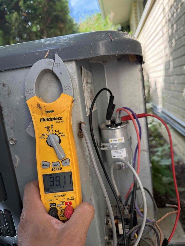 Responded to no cooling complaint on residential air conditioning system. Upon arrival, verified unit was running but not cooling effectively. Performed diagnostic evaluation of outdoor condensing unit including electrical component inspection. Used clamp meter to measure amperage draw, recording 39.1 amps at compressor circuit. Inspected capacitor, contactor assembly, and associated wiring connections for proper operation and signs of failure. All electrical connections were evaluated for integrity and proper voltage supply to ensure system functionality.