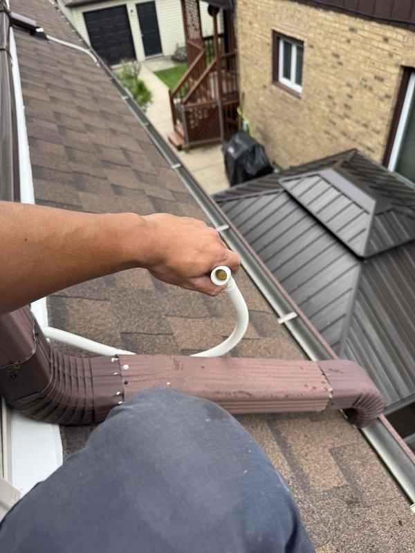 Responded to emergency service call for leaking ductless mini-split unit approximately two months post-installation. Conducted thorough inspection of wall-mounted indoor evaporator unit in bedroom and traced condensate drainage system to exterior rooftop discharge point. Identified improper condensate line routing causing water leakage, corrected drainage configuration using PVC components, and verified proper pitch and flow to exterior gutter system. Confirmed unit operation and resolved leak under warranty coverage.