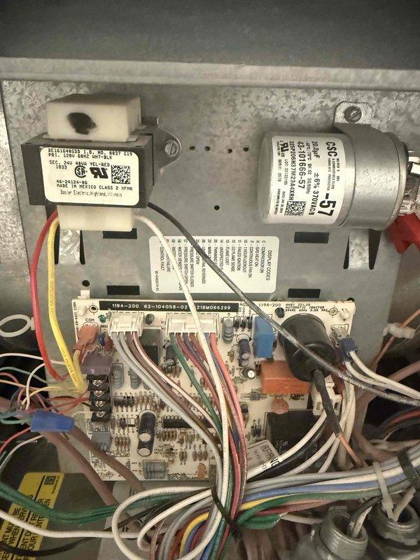 Completed comprehensive clean and check maintenance service on two air conditioning systems per comfort plan agreement. Performed standard preventive maintenance procedures including inspection of electrical components, capacitors, and control boards on both units. Addressed active refrigerant leak at copper service port connection on outdoor unit, with water spray visible during service indicating need for potential system repair or component replacement. Documented equipment conditions through photos of outdoor condenser unit and interior electrical compartment showing control board, capacitor, and wiring connections. Customer expressed interest in early comfort plan renewal.