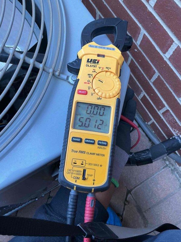 Completed comprehensive clean and check maintenance service on single air conditioning system as part of comfort plan agreement. Performed electrical diagnostics using clamp meter to verify system amperage and voltage readings, confirming unit operating within manufacturer specifications at 336.2V and 50.12 readings respectively. Collected payment for comfort plan renewal and documented system condition with photos showing outdoor condenser unit and electrical measurements.