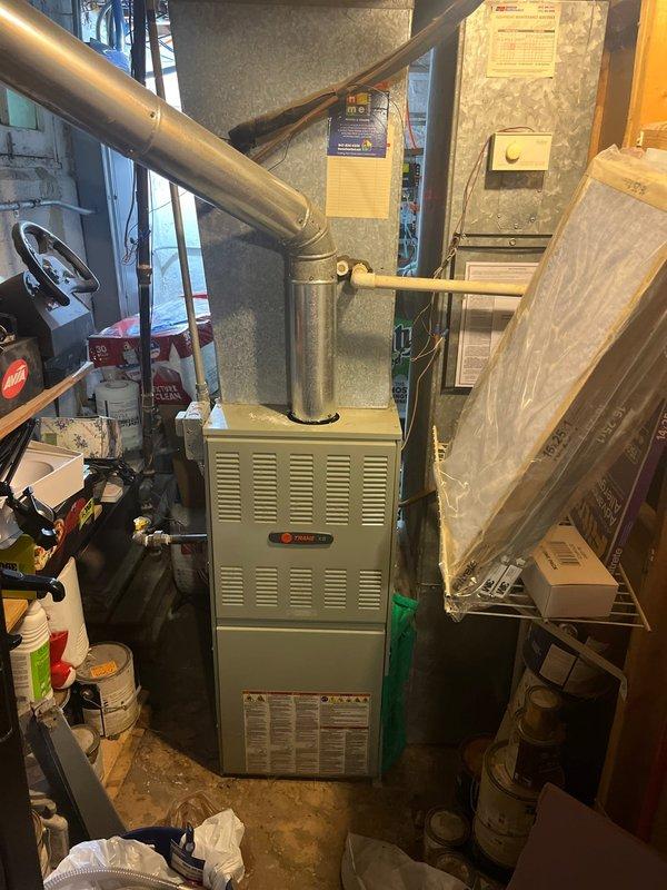 Conducted comprehensive assessment of residential HVAC system in response to loud rattling noise from air conditioning unit during startup. Inspection revealed cracked heat exchanger in Payne brand furnace located in basement utility area, posing safety concern requiring furnace replacement. Evaluated outdoor condenser unit and identified failed condenser fan motor as source of abnormal noise, though unit maintained cooling capacity. Documented equipment conditions with photographic evidence and provided detailed estimate for complete furnace replacement and AC condenser fan motor replacement to restore safe, quiet system operation.