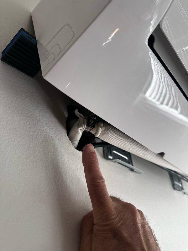 Conducted warranty follow-up inspection on wall-mounted mini-split system to assess condensate drainage routing. Evaluated current drain line configuration and determined optimal path to redirect condensate discharge to front of residence, inspecting both interior unit connections and exterior roof-mounted drainage components to ensure proper gravity flow and code compliance.