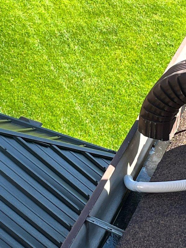 Conducted warranty follow-up inspection on wall-mounted mini-split system to assess condensate drainage routing. Evaluated current drain line configuration and determined optimal path to redirect condensate discharge to front of residence, inspecting both interior unit connections and exterior roof-mounted drainage components to ensure proper gravity flow and code compliance.