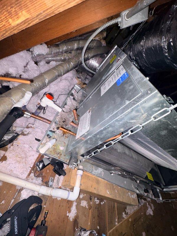 Completed warranty replacement of leaking evaporator coil on Unico system air handler located in attic space. Removed defective coil, installed replacement unit, reconnected refrigerant lines and condensate drainage, evacuated system, and charged to manufacturer specifications using digital manifold gauges to verify proper pressures and system operation.