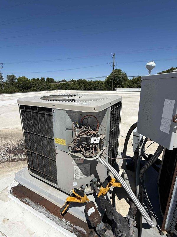 Responded to no cooling complaint on commercial rooftop unit. Previous breaker issue had been addressed, but unit still not cooling properly. Upon arrival, accessed rooftop unit and removed side panel to inspect internal components. Connected manifold gauges to measure refrigerant pressures and temperatures. Initial diagnostic readings showed suction pressure at 58.2 psig with 63.6°F temperature, resulting in 31.2°F superheat on R-22 system. Liquid line pressure measured 183.7 psig at 80.7°F with 15.0°F subcooling. System analysis indicated abnormal operating conditions preventing adequate cooling performance. Documented beginning temperatures and pressures for diagnostic purposes.